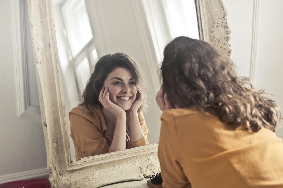 girl looking at self in mirror